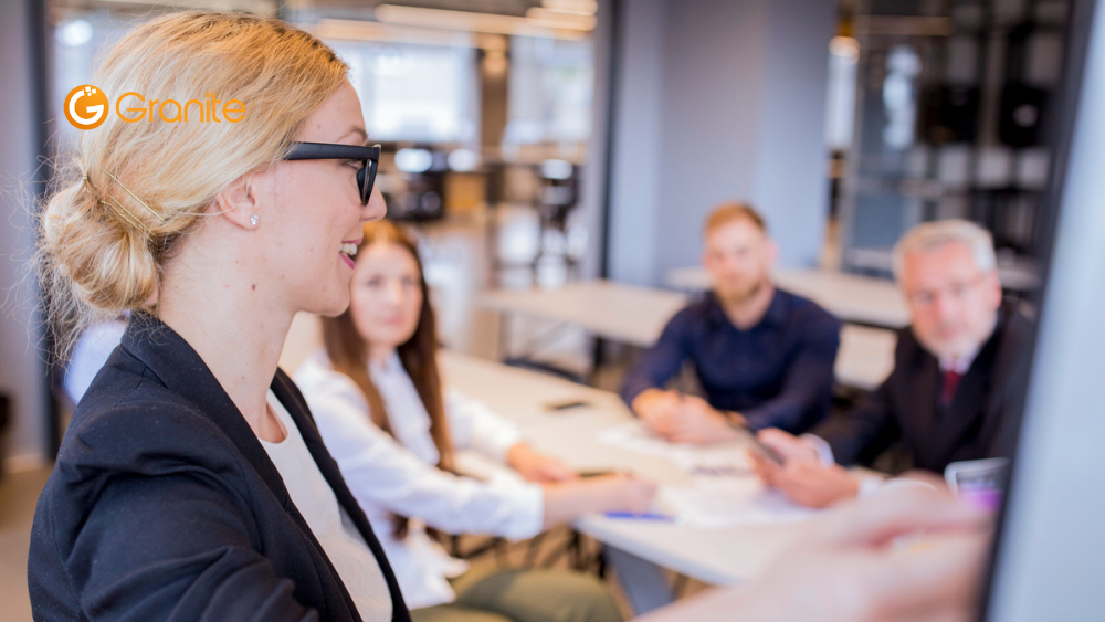 Team gathered in a meeting room discussing risk management and resilience strategies, illustrating collaborative planning as highlighted in the article "Resilience is the Future of Risk Management – How to Build an Organisation That Can Withstand Disruption"